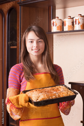 Photo: beautiful girl with cake in kitchen beautiful girl with cake in kitchen