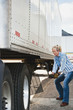 Photo: Woman Truck Driver Raising Trailer legs Woman Truck Driver Raising Trailer legs