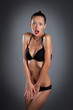 young woman in black lingerie scary closed pose