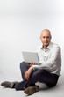 Photo: Portrait of middle-aged man with a white laptop computer Portrait of middle-aged man with a white laptop computer