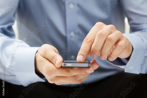 Foto: Close up of a man using smartphone Close up of a man using smartphone