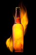 Beer bottle in fire on black