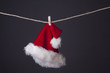 Santa hat hanging isolated on grey