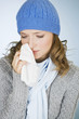 A young woman wiping her tears away with a tissue