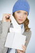 A young woman taking a tissue out of a tissue box