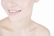 A lower half of a young woman's face, smiling