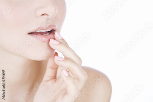 Photo: A young woman's face, fingers touching her mouth A young woman's face, fingers touching her mouth