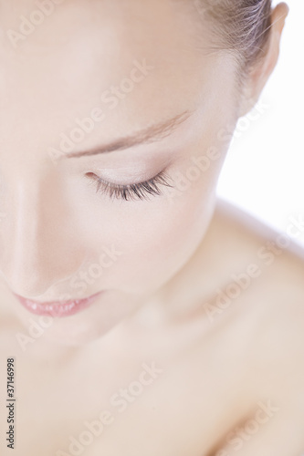 Photo: A young woman looking down, cropped A young woman looking down, cropped