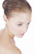 Portrait of a young woman with blue eyes, looking down