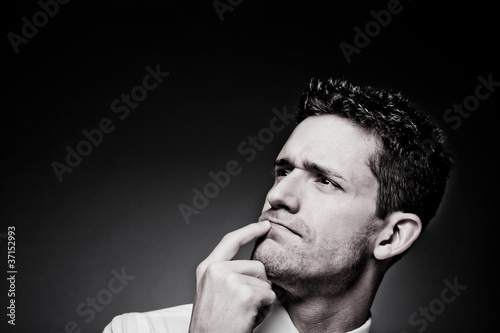 Photo: Young confident man solving a problem. Young confident man solving a problem.