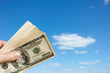 Photo: Hand holds up $100 bills Hand holds up $100 bills