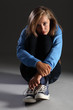Scared teenager girl on floor stressed and alone