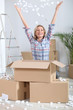 Woman joyously unpacking boxes