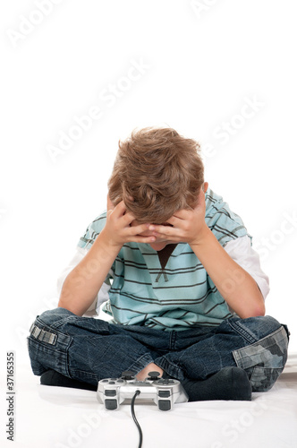 Photo: Child playing a video game Child playing a video game