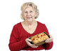 Senior woman holding a fruit cake Senior woman holding a fruit cake