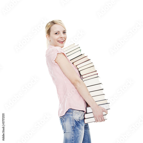 Foto: young blonde attractive woman holding a pile of books young blonde attractive woman holding a pile of books