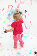 Little toddler girl painting with colors on white wall Little toddler girl painting with colors on white wall