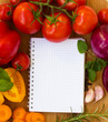 blank notebook for recipes with colorful vegetables