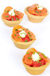 Appetizers with salmon and tomatoes isolated on white background