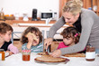 Mother preparing breakfast for kids