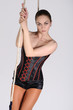 Young woman on trapeze, on white background.