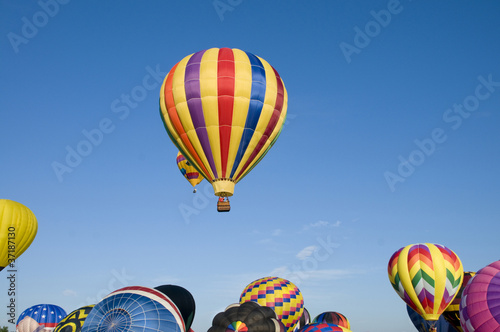 Photo: Hot-air balloons ascending over inflating ones Hot-air balloons ascending over inflating ones