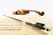 Vintage viola with bow close-up and sheet music