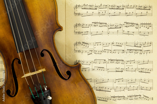 Photo: Vintage viola on sheet music background Vintage viola on sheet music background