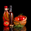 Tomatoes and garlic in wooden plate on black background. Tomatoes and garlic in wooden plate on black background.