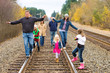 Photo: Group of people walking down the train tracks Group of people walking down the train tracks