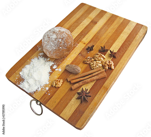 Photo: Christmas spices and dough on wooden board Christmas spices and dough on wooden board
