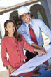 Foto: Man Architect & Woman With Plans on Construction Site Man Architect & Woman With Plans on Construction Site