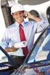 Businessman Architect In Hard Hat On Cell Phone By Car