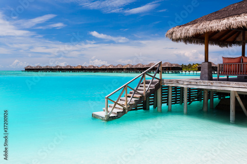 Photo: Over water bungalow with steps into blue lagoon Over water bungalow with steps into blue lagoon