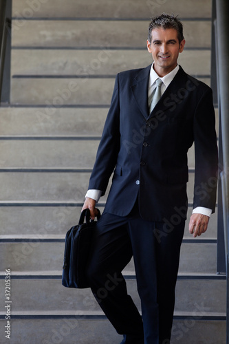 Photo: Male Entrepreneur Walking Down Stairs Male Entrepreneur Walking Down Stairs