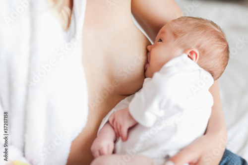 Photo: Mother suckling her newborn Mother suckling her newborn