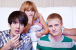 Teens eat popcorn