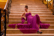woman in a long dress lying on the stairs