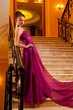 woman in a beautiful dress sloit on the stairs