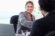 Smiling businesswoman welcomes customer