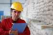 Foto: Worker writing results in Warehouse Worker writing results in Warehouse