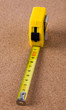 Tape measure isolated on wooden background Tape measure isolated on wooden background