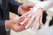 Newly-married couple on wedding dresses gold rings