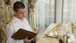 young man chooses a meal in the restaurant's menu