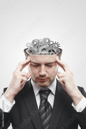Photo: Open minded man with gears and cogs inside Open minded man with gears and cogs inside