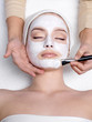 Facial mask on face of young woman