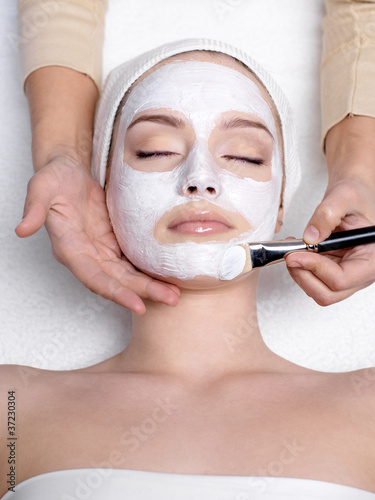 Photo: Facial mask on face of young woman Facial mask on face of young woman