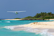Foto: Small tourist plane over Caribbean beach in Mexico Small tourist plane over Caribbean beach in Mexico