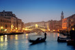 Rialto Bridge and gondolas at a foggy autumn evening in Venice.
