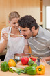 Portrait of a young couple preparing a sauce